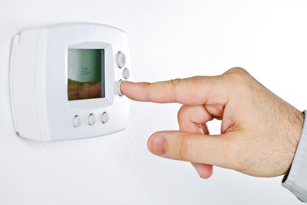 image of person lowering thermostat