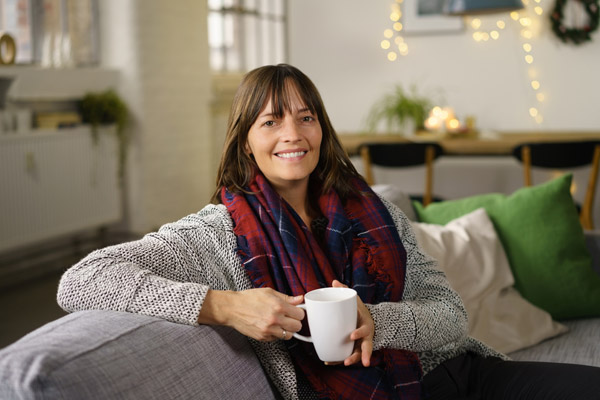 woman enjoying warm home heated by fuel oil