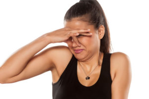 woman plugging nose from heating oil odor