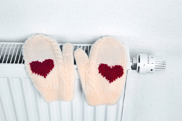 mittens on radiator depicting boiler temperature settings