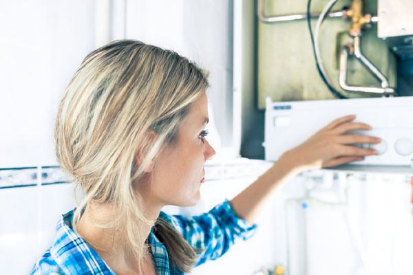 image of a homeowner inspecting their oil-fired water boiler