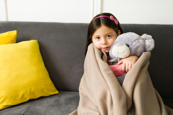 image of a girl feeling chilly due to running out of heating oil in winter