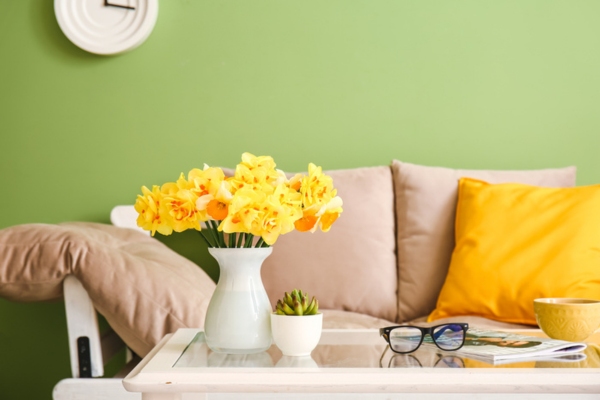 cozy living room with fresh flowers in vase depicting spring time